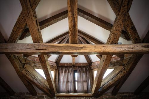a ceiling with wooden beams and a window at Kuća za odmor Raguž in Andrijaševci