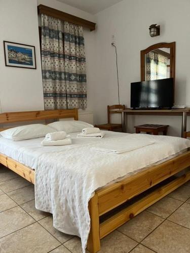 a bedroom with a bed with two towels on it at LAURA Skiathos in Skiathos Town