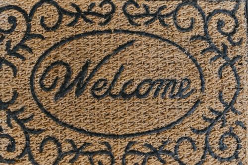 a close up of the welcome sign on the floor at Urban Nest in Ljubuški