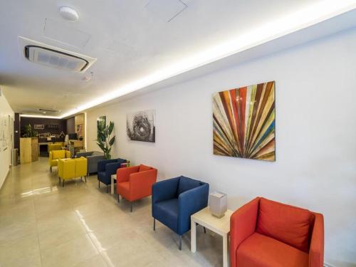 a waiting room with colorful chairs in a hospital at OYO 264 City Edge Hotel in Kuala Lumpur