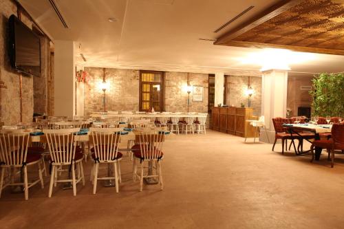 a dining room with tables and chairs in a building at Orchis Hotel in Ayvalık