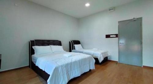 a bedroom with two beds and a sliding glass door at OYO 89859 PP Traveller's Hotel in Pasir Puteh