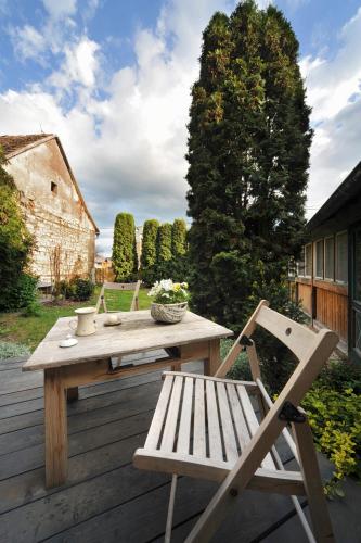 a wooden table and a bench on a wooden deck at Galerie Kuks in Kuks