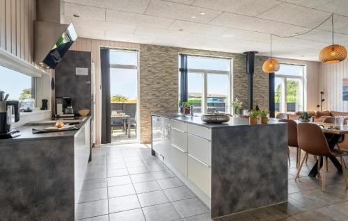a kitchen with a counter and a dining room at Holiday Home Haderslev With Fireplace 09 in Store Anslet
