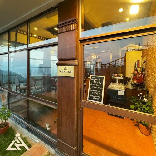 a store front window of a restaurant with a sign in it at Chandragiri Hills Resort Kathmandu-Luxury in the Clouds in Thānkot