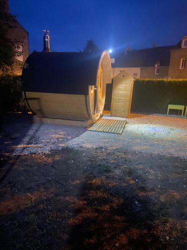a large boat is parked in a yard at night at Gîtes le Mont Desclos Saint Michel in Beauvoir