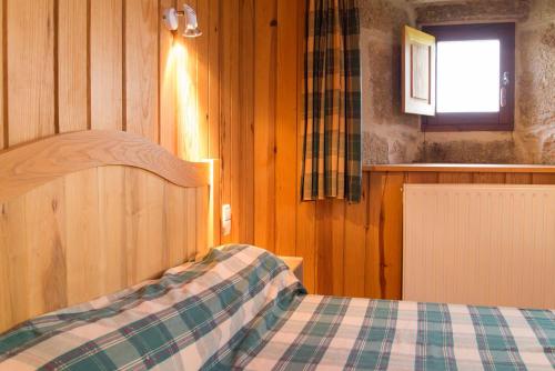a bedroom with a bed with a checkered blanket at Gîte Gîtes de France 9/11 personnes à Brion in Brion