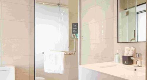 a bathroom with a sink and a toilet and a mirror at City Comfort Inn Ji'an South Administrative Center in Ji'an