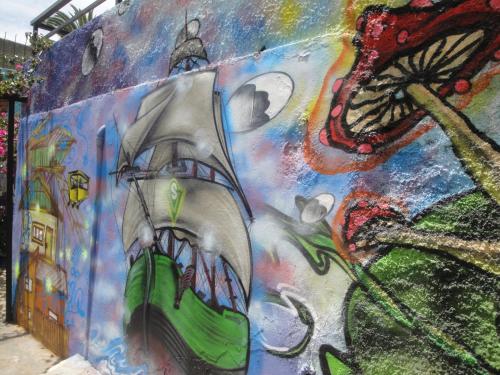 a wall with a painting of a ship on it at The Travelling Chile in Valparaíso