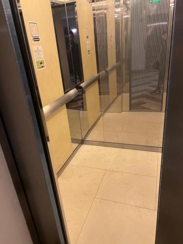 a hallway with a door and a metal railing at orbi beach tower in Itʼkhvisi