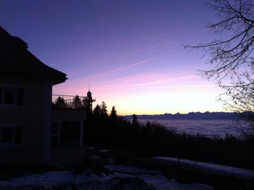 a view of the sunset from the balcony of a house at Petit Hôtel de Chaumont in Chaumont-de-Pury