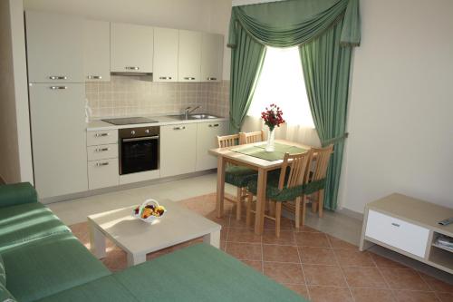 a kitchen and a living room with a table and a couch at Ferienhaus Dakovic in Poreč