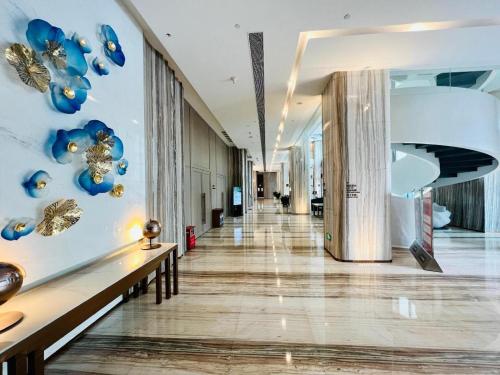 a hallway in a building with blue and gold decorations at Zhuhai Hongsanyi Hotel in Zhuhai