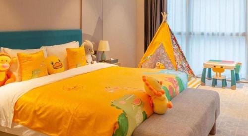 a childs bedroom with a large yellow bed with a toy tent at Zhuhai Hongsanyi Hotel in Zhuhai