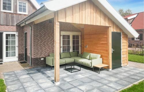 a pergola with a couch on a patio at Buitengoed Het Lageveld - 93 in Hoge-Hexel