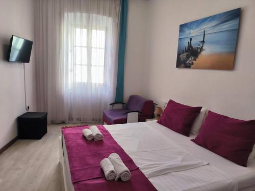 a bedroom with a bed with two slippers on it at Omir Bed & Breakfast in Pula