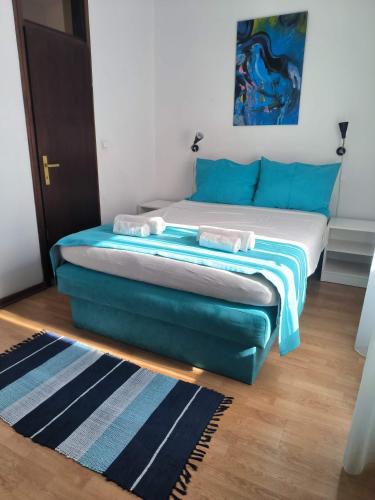 a bedroom with a bed with blue and white sheets at Omir Bed & Breakfast in Pula