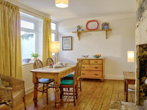 a dining room with a wooden table and a dresser at The Nook in Alnwick