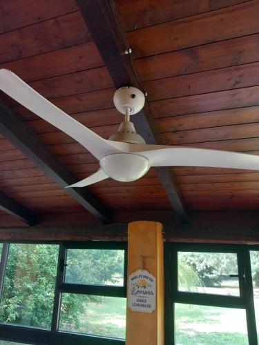 a ceiling fan hanging from a wooden ceiling at La Casa di Gio ed Eli in Voghera