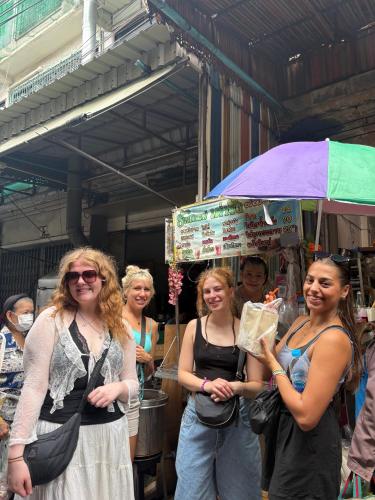 a group of women standing under an umbrella at Here We Go Bangkok in Bangkok