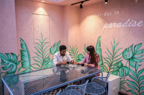 a man and a woman sitting at a table at Theory9 Premium Service Apartments Bandra in Mumbai