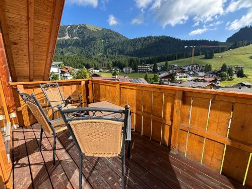a balcony with chairs and a view of a mountain at Appartements Berwang in Berwang