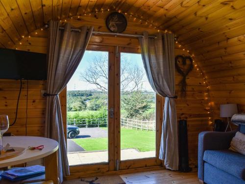 a room with a large window in a log cabin at Jacob's Den - Uk40976 in Felindre