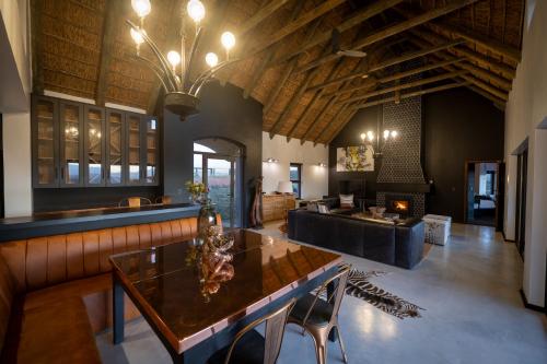 a living room with a table and a couch at Gondwana Game Reserve in Kleinberg