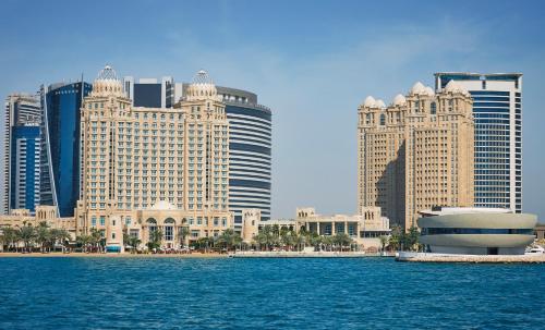 a view of a city from the water with buildings at Four Seasons Hotel Doha in Doha