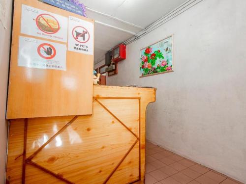 a room with a wooden counter and a refrigerator at OYO 89706 To-day Hotel in Sibu