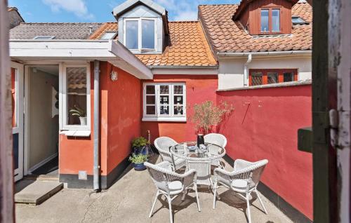 a patio with a table and chairs in front of a building at 1 Bedroom Lovely Home In Assens in Assens