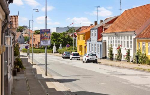 a street in a town with cars driving down the street at 1 Bedroom Lovely Home In Assens in Assens