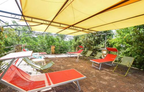 a group of chairs and tables on a patio at Stunning Apartment In San Vito In Monte in Baccano