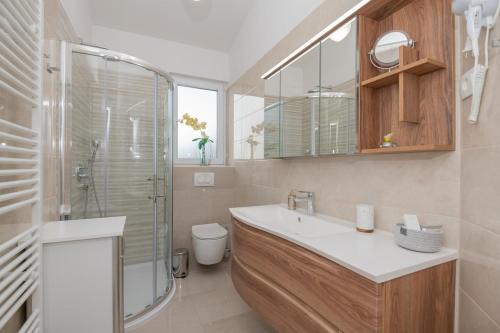 a bathroom with a sink and a glass shower at Villa Miramel mit privaten Swimmingoool - Makarska Exklusiv in Makarska
