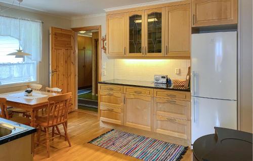 a kitchen with a white refrigerator and a table at Awesome Home In Åheim With Wifi in Åheim