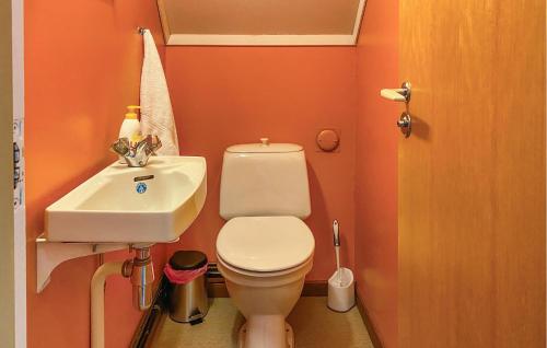 a small bathroom with a toilet and a sink at Awesome Home In Åheim With Wifi in Åheim