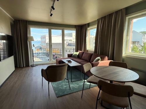 a living room with a couch and a table at Scandic Harstad in Harstad