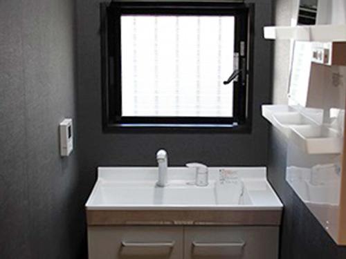 a bathroom with a white sink and a window at Koiya in Kameoka