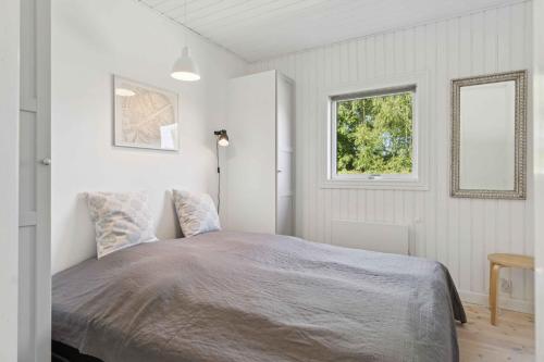 a bedroom with a bed and a window at Spacious, Lovely Cottage In North Zealand in Melby