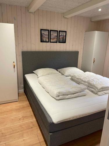 a large bed with white sheets and pillows at Cozy And Child-Friendly Holiday Home In Arrild in Toftlund