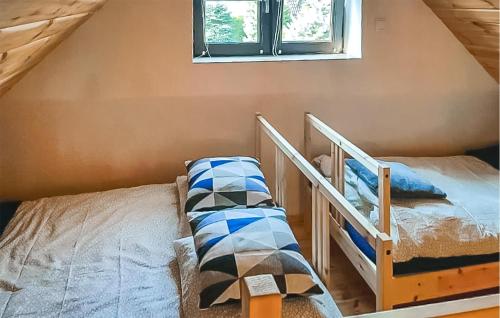 a bedroom with two bunk beds and a window at Stunning Home In Cieciorka in Cieciorka