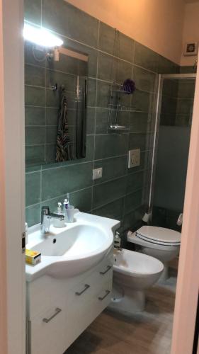 a bathroom with a white sink and a toilet at Camera Il gabbiano in Marina di Campo
