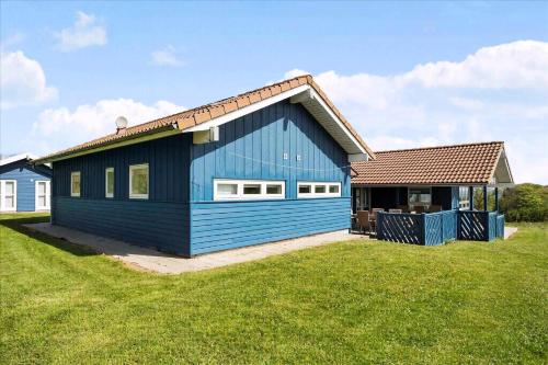 a blue house with a brown roof at Beach, Starry Sky And Peace By The Water in Augustenborg
