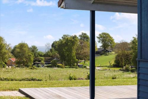 a view of a field from the porch of a house at Beach, Starry Sky And Peace By The Water in Augustenborg