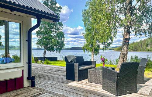 a porch with chairs and a view of a lake at 2 Bedroom Cozy Home In Sandöverken in Sandöverken