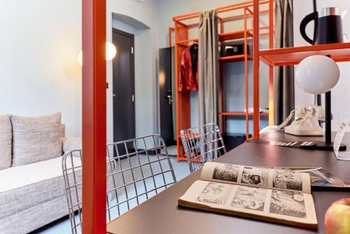 a room with a desk with a book and a bed at Stay Swanky Bed & Breakfast in Zagreb