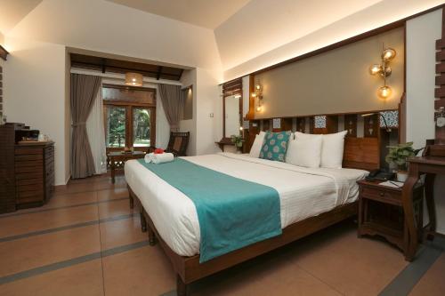 Postel nebo postele na pokoji v ubytování Greenwoods Resort, Thekkady