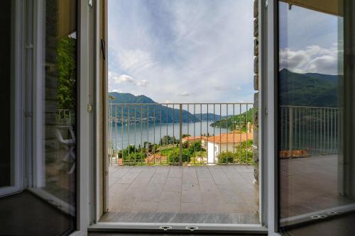 an open window with a view of the water at Como Lake Amazing View - byMyHomeinComo in Moltrasio