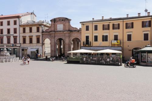 a group of people walking around in a city square at TEATRUM LOFT Teatro Galli -Jacuzzi in camera in Rimini
