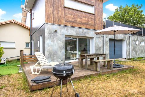 a backyard with a bbq and a grill at Studio Judicaelle in Lège-Cap-Ferret